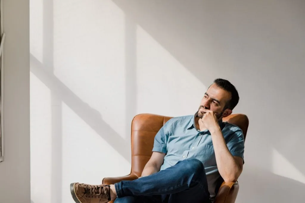 Man sitting in a chair thinking