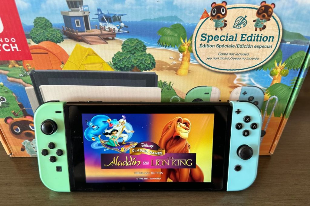 Nintendo Switch console with Aladdin and Lion King on the screen 