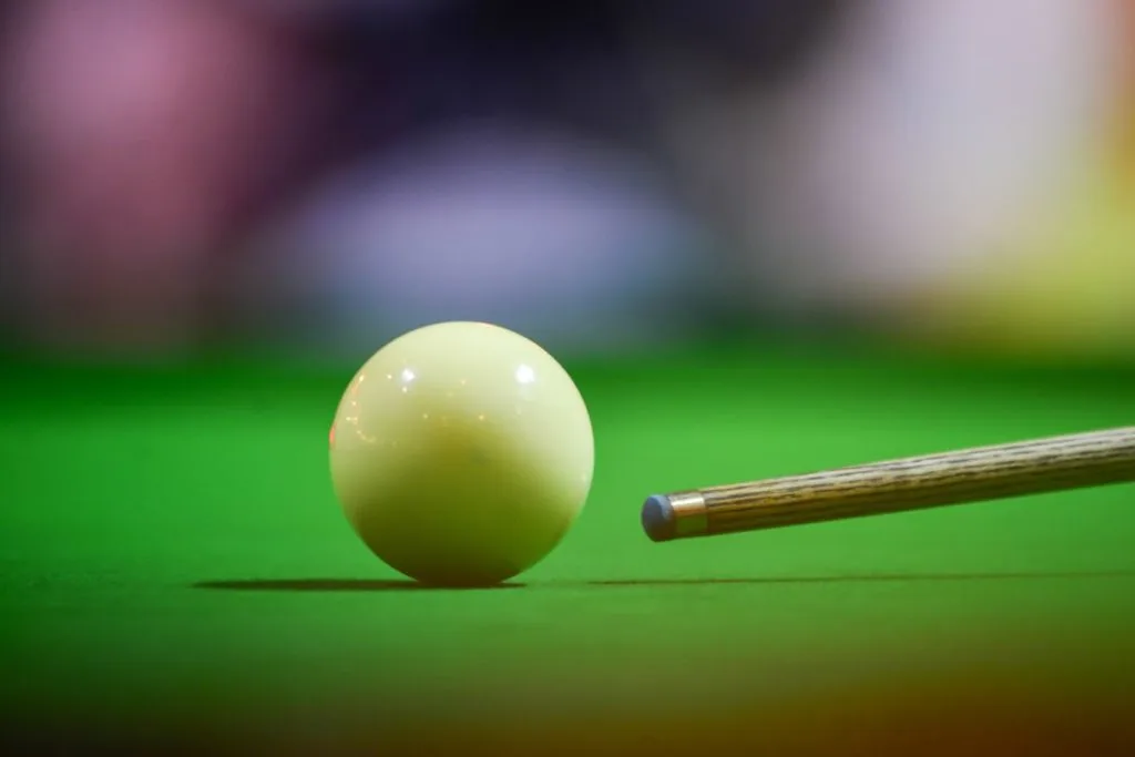 Person getting ready to hit a cue ball
