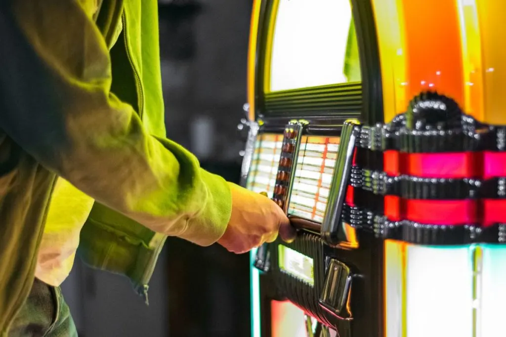 Person putting money in a jukebox