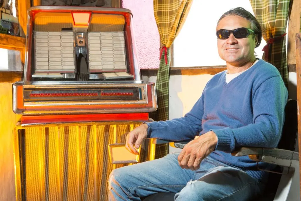 Person sitting by an antique jukebox