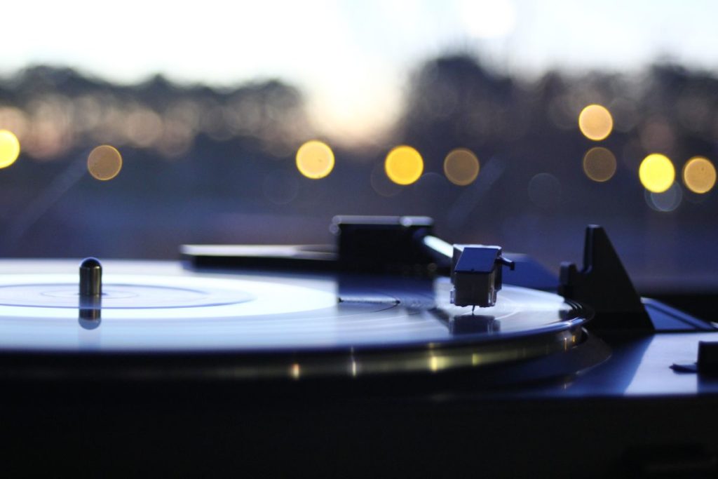 Record player with city lights in the background