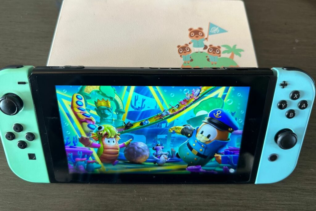 Nintendo Switch and Dock With Fall Guys on the screen